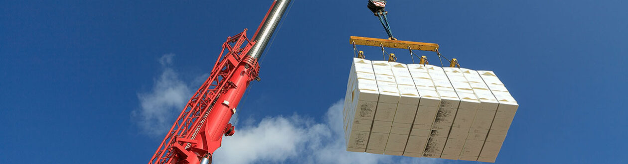 Crane lowering pulp bales into a barge at the Mercer Stendal pulp mill in Arneburg, Germany