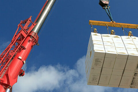 Crane lowering pulp bales into a barge at the Mercer Stendal pulp mill in Arneburg, Germany
