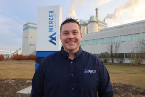 Adam Wilcox, the health and safety representative stands in front of the Mercer Peace River pulp mill