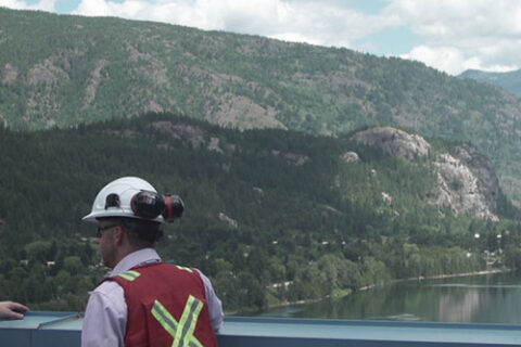 Two Mercer Celgar employees overlooking the Nelson River in British Columbia, Canada, from the pulp mill's roof