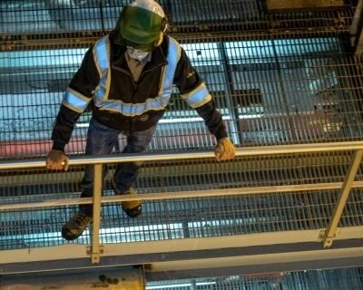 Team member at Mercer Celgar looking down at the mill floor