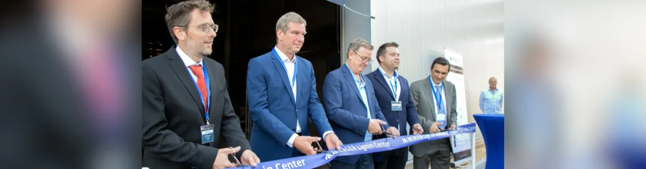 Five men in suits cut a blue ribbon for the "Mercer Lignin Center" opening ceremony.