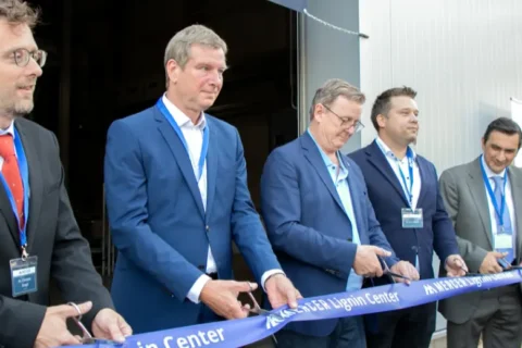 Five men in suits cut a blue ribbon for the "Mercer Lignin Center" opening ceremony.