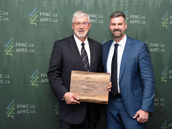 Joerg Goetsch, retiree and Director of Strategic Initiatives for Western Canada for Mercer International's Vancouver team, receives Lifetime Achievement Award from Derek Nighbor, FPAC President and CEO, September 2022.